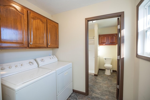 laundry area featuring cabinets and washing machine and clothes dryer