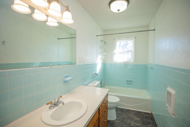 full bathroom with vanity, bathtub / shower combination, tile walls, and toilet