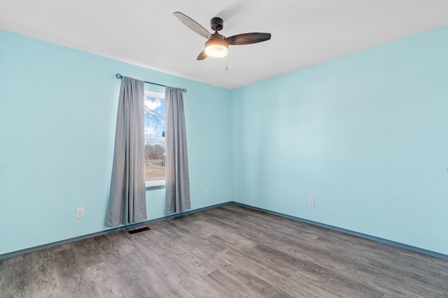 empty room featuring hardwood / wood-style flooring and ceiling fan