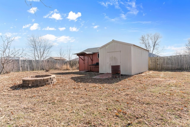 view of outbuilding featuring an outdoor fire pit