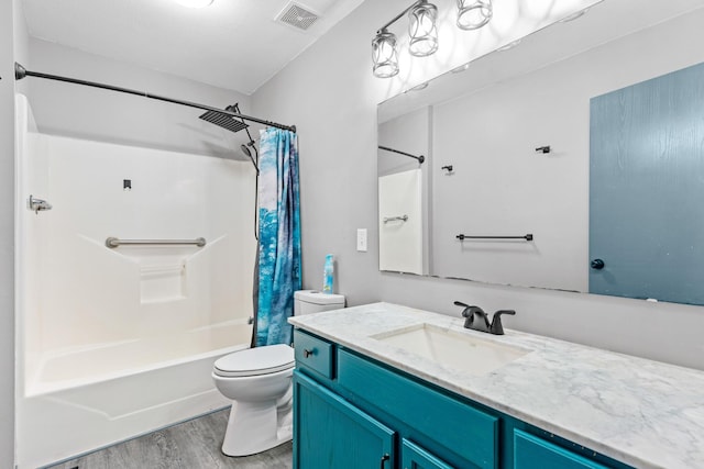 full bathroom featuring vanity, hardwood / wood-style flooring, toilet, and shower / bath combo with shower curtain