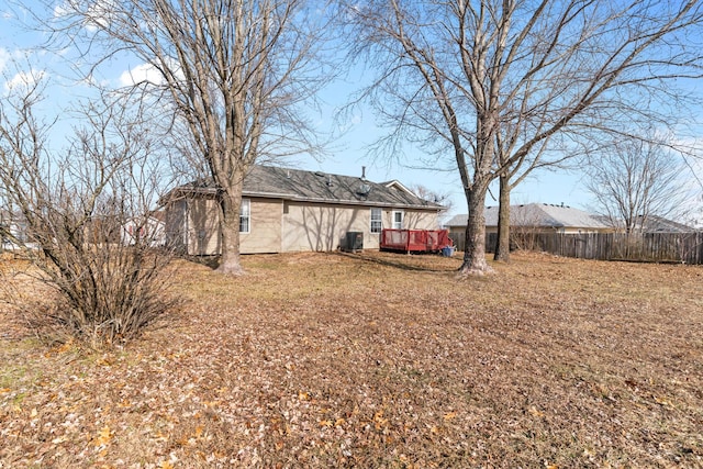 view of yard with a deck and central air condition unit