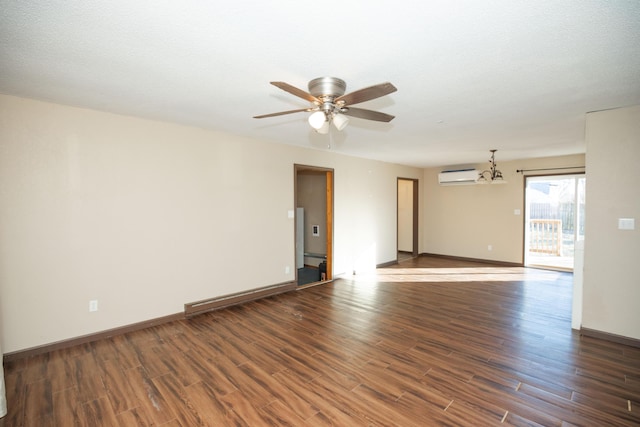 unfurnished room with dark hardwood / wood-style floors, ceiling fan with notable chandelier, an AC wall unit, and a textured ceiling