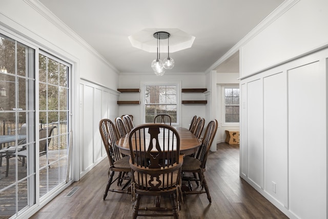 dining area featuring crown molding and dark wood-type flooring