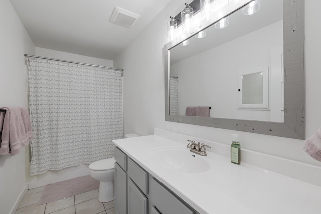 full bathroom featuring shower / bath combo with shower curtain, tile patterned floors, toilet, and vanity