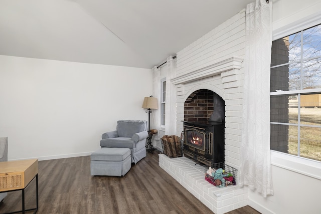 living area with lofted ceiling, a healthy amount of sunlight, and dark hardwood / wood-style flooring