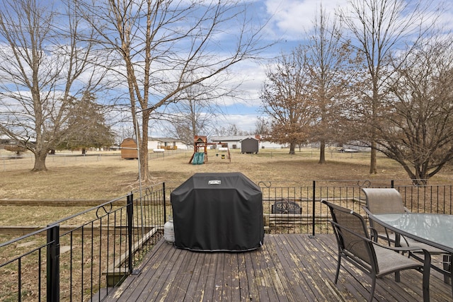 deck featuring a grill and a playground