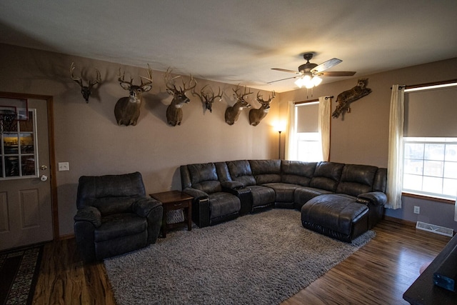 living room with dark hardwood / wood-style floors and ceiling fan