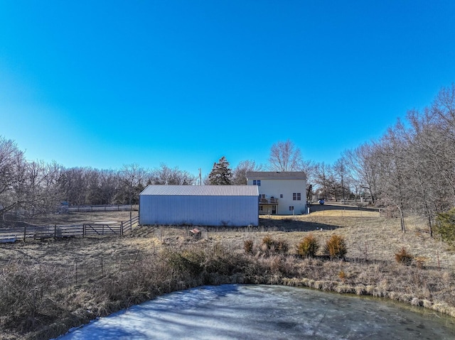 view of side of home featuring a rural view