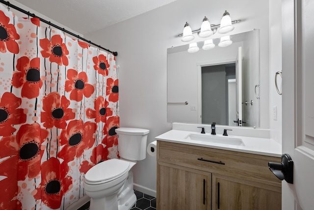 bathroom with vanity, tile patterned floors, and toilet