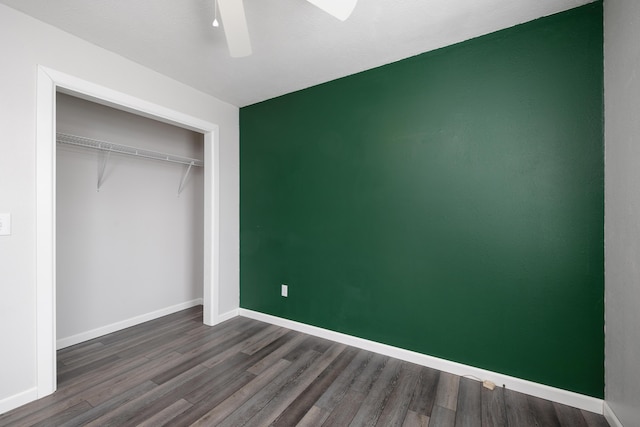 unfurnished bedroom with ceiling fan, dark hardwood / wood-style floors, and a closet