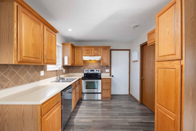 kitchen featuring sink, backsplash, dark hardwood / wood-style floors, and appliances with stainless steel finishes