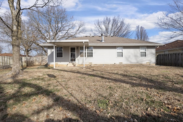 back of house featuring a yard