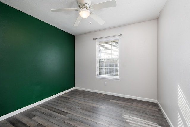 spare room featuring ceiling fan and dark hardwood / wood-style flooring