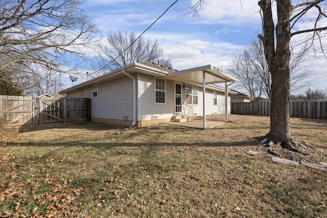 rear view of house with a yard and a patio area