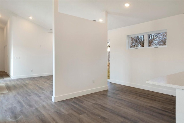 unfurnished room with dark hardwood / wood-style flooring and vaulted ceiling