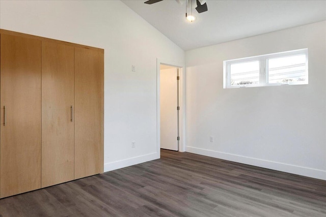 unfurnished bedroom featuring a closet, high vaulted ceiling, dark hardwood / wood-style floors, and ceiling fan