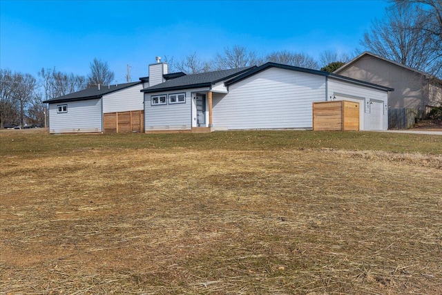 ranch-style house with a garage and a front lawn