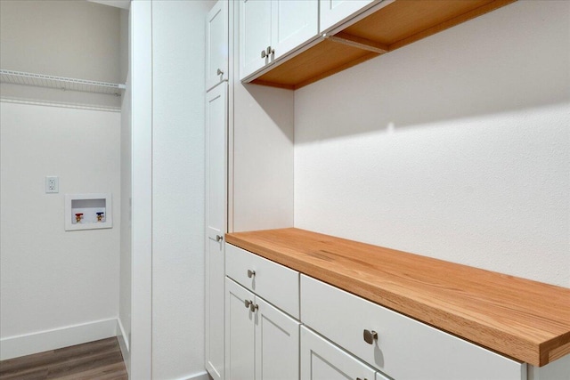 laundry area with hookup for a washing machine, cabinets, and hardwood / wood-style flooring