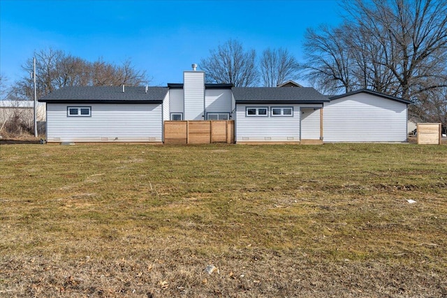 rear view of property with a yard