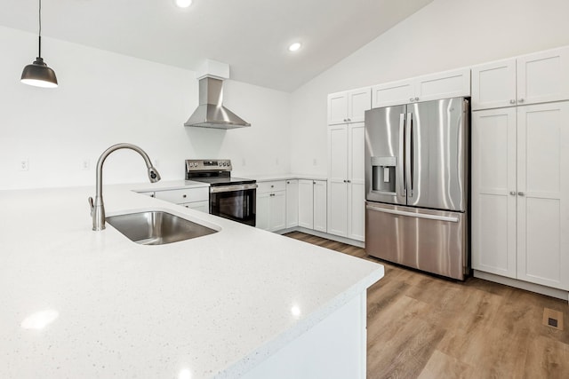 3481 W Moark St, Springfield, MO 65810 - kitchen featuring appliances with stainless steel finishes, wall chimney exhaust hood, lofted ceiling, light wood finished floors, and pendant lighting