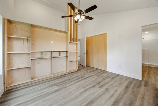 3481 W Moark St, Springfield, MO 65810 - unfurnished bedroom featuring wood finished floors, a towering ceiling, a closet, and a ceiling fan