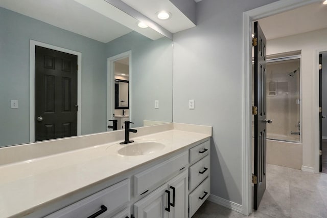 bathroom featuring vanity and shower / bath combination with glass door