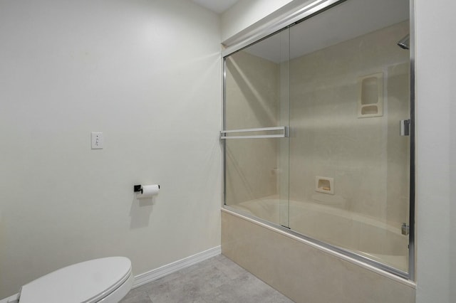 bathroom featuring shower / bath combination with glass door and toilet