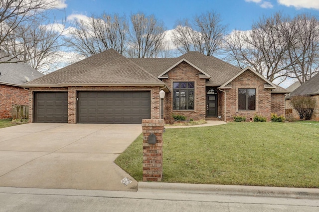 view of front of property with a garage and a front yard