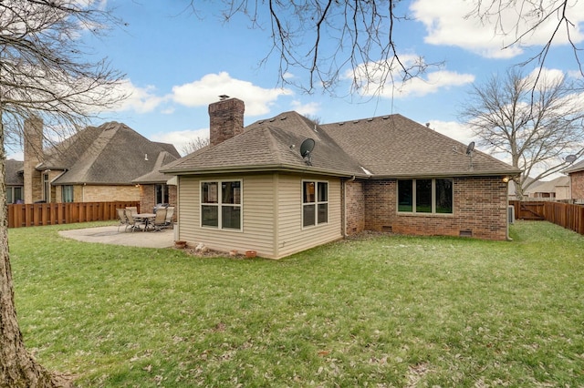 rear view of property with a yard and a patio