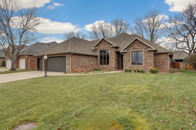 view of front of house featuring a garage and a front lawn