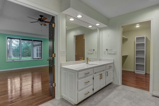 bathroom with vanity, hardwood / wood-style floors, and ceiling fan