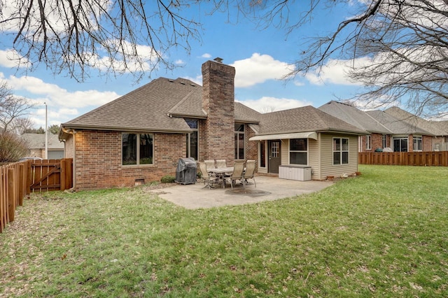 rear view of property with a yard and a patio area