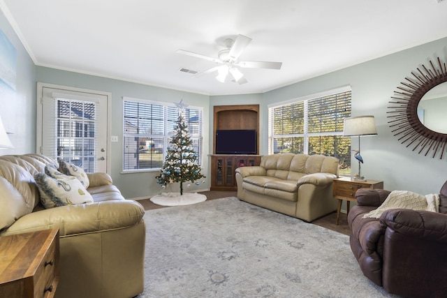 living room with ornamental molding and ceiling fan