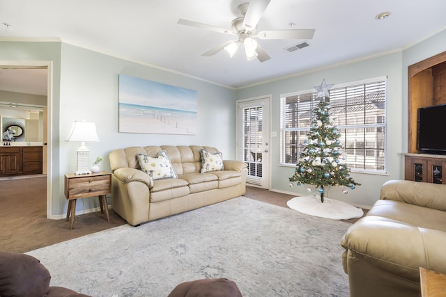 living room featuring crown molding, ceiling fan, and carpet flooring