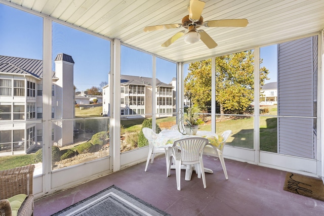 sunroom with wood ceiling and ceiling fan