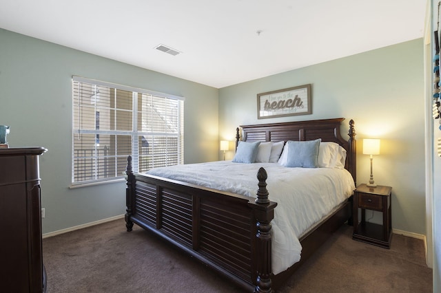 bedroom with dark colored carpet