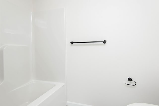 bathroom featuring toilet and a bathing tub