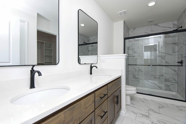 bathroom featuring vanity, walk in shower, and toilet