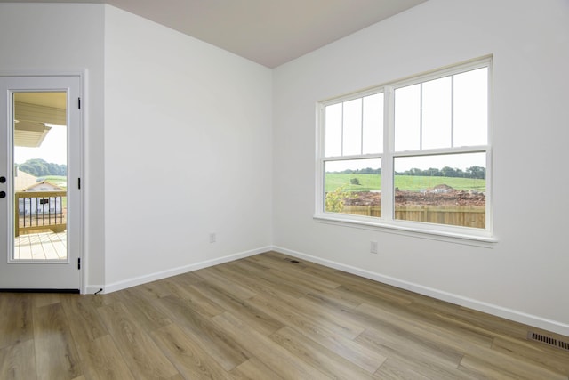 spare room with light hardwood / wood-style floors