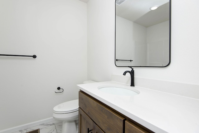 bathroom with vanity and toilet