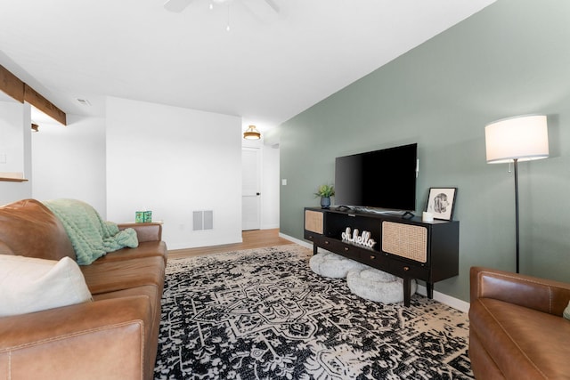 living room featuring hardwood / wood-style flooring and ceiling fan