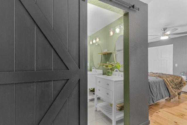 bathroom featuring vanity, hardwood / wood-style floors, and ceiling fan