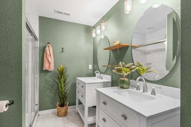 bathroom featuring vanity and a shower with shower door