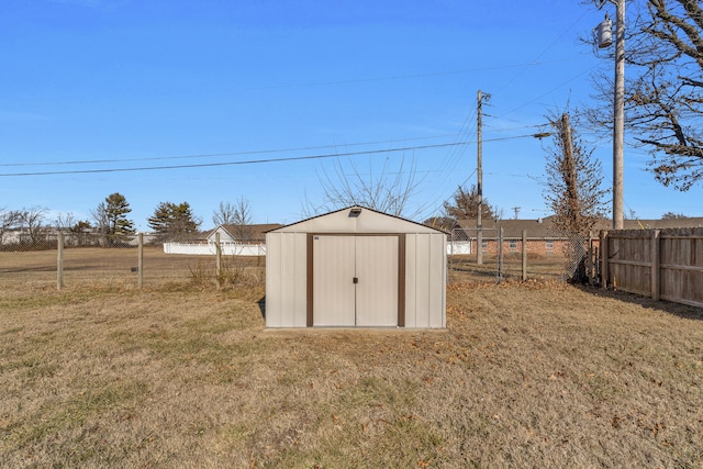 view of outbuilding with a yard