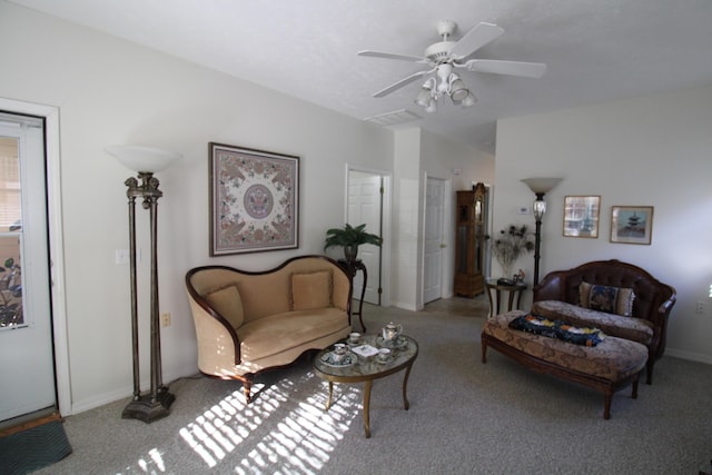 carpeted living room with ceiling fan