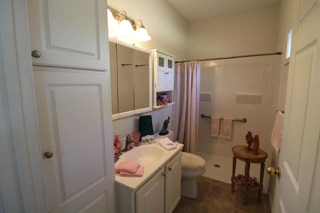 bathroom with vanity, curtained shower, tile patterned floors, and toilet