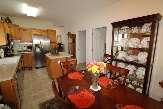 tiled dining space featuring sink