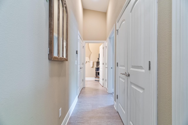 hallway with light hardwood / wood-style flooring