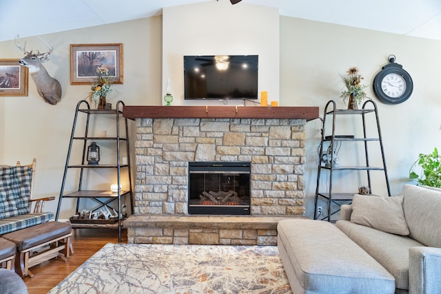 living room featuring hardwood / wood-style flooring, a fireplace, and vaulted ceiling with beams